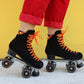 Chuffed Skates black roller skates with yellow wall behind 