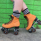 Orange Chuffed Roller Skates with green wall