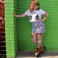 Ginger roller skater wearing Orange Chuffed Roller Skates with green wall