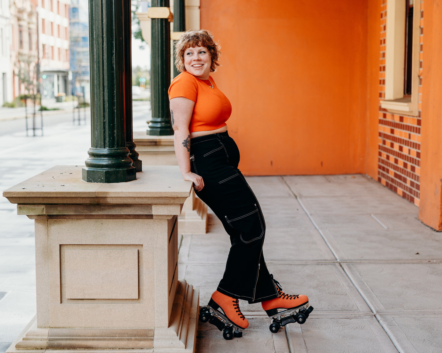 Orange Pro Boot rollerskate, Sophie with orange background