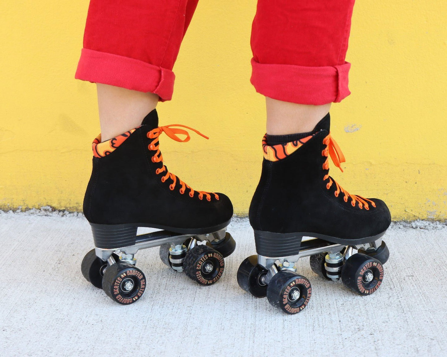 Chuffed Skates black roller skates  with yellow background